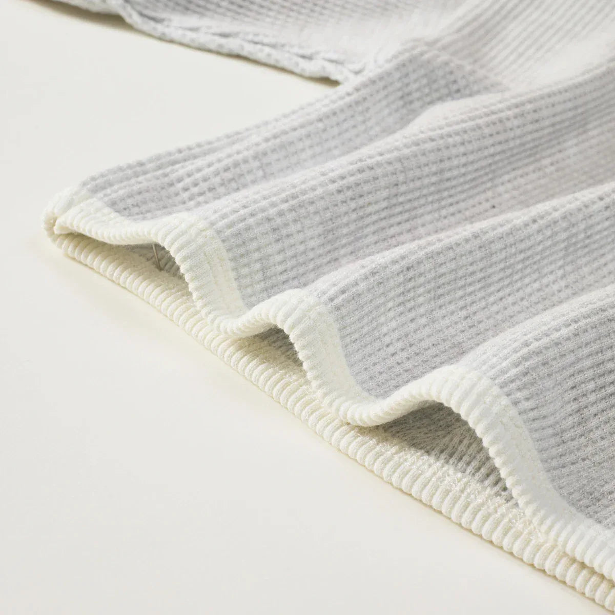 gray and white babies warm up outfit with waffle texture and scalloped edges