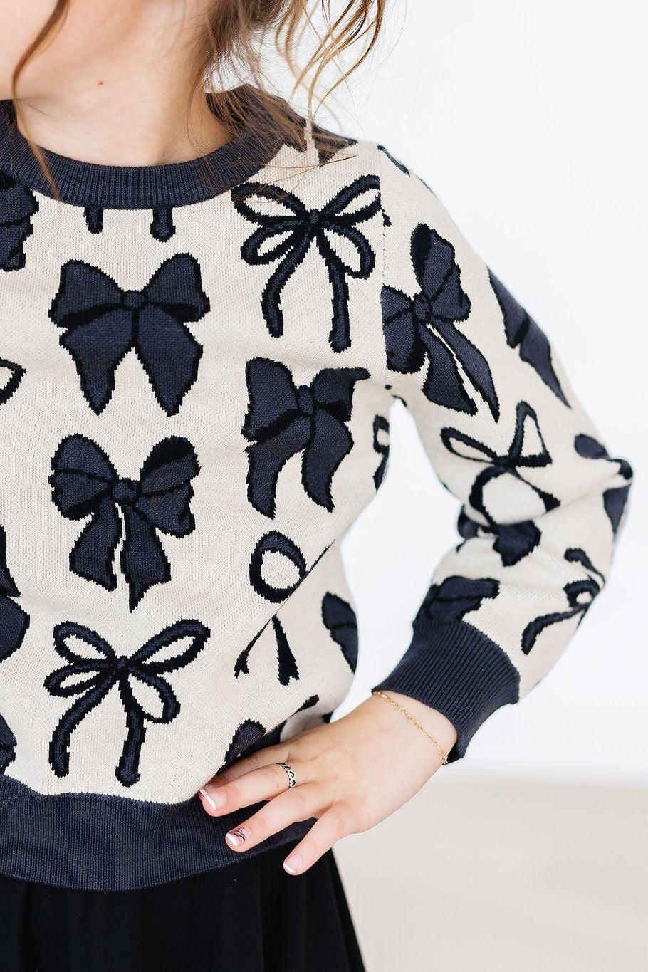 Women's cream and black knit sweater with bow pattern and long sleeves by Mila & Rose