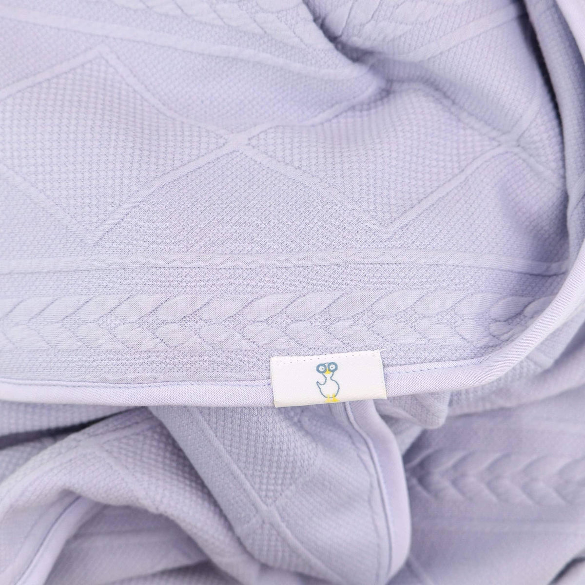 Lavender knit baby blanket made from soft breathable cotton with textured diamond and braided patterns