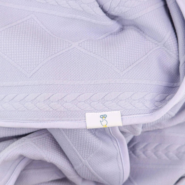 Lavender knit baby blanket made from soft breathable cotton with textured diamond and braided patterns
