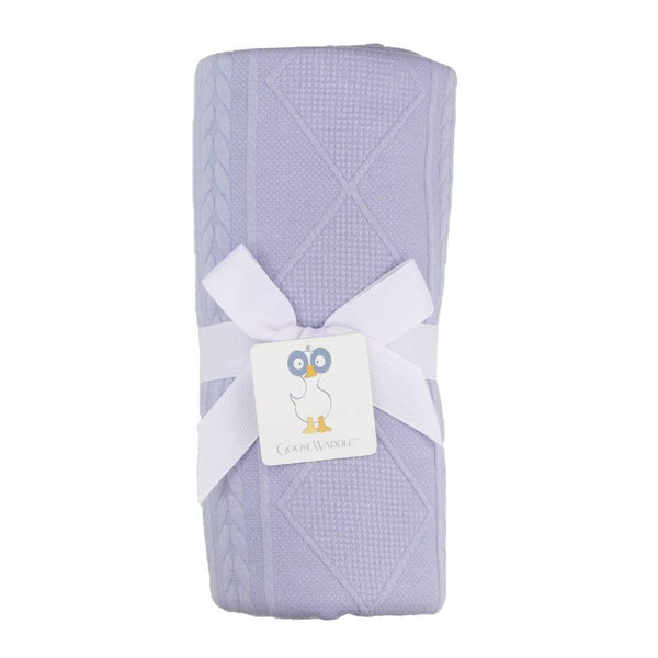 Lavender knit baby blanket made from soft material with textured diamond and cable patterns