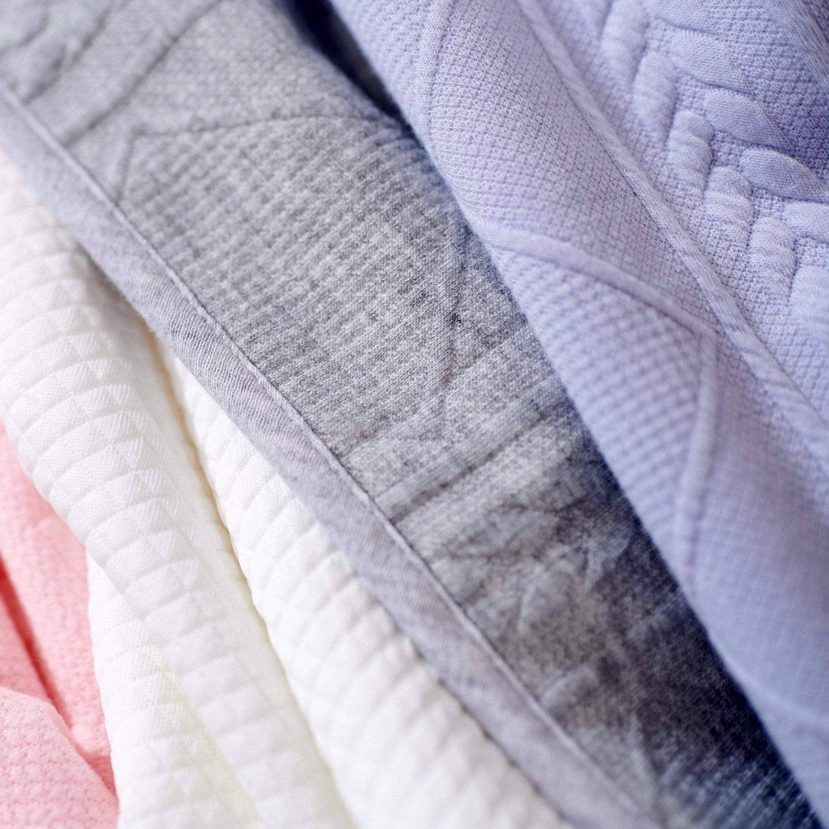 Lavender knit baby blanket made of soft cotton fabric with textured patterns