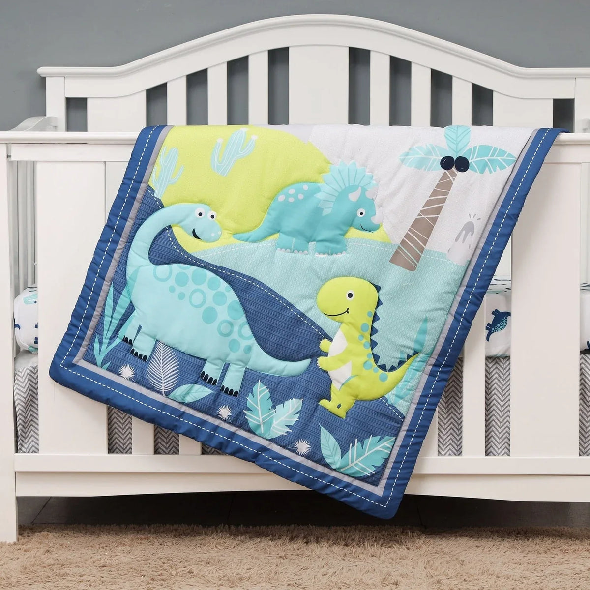 Baby dinosaur comfort set quilt in blue green and yellow with playful dinosaur designs for infants