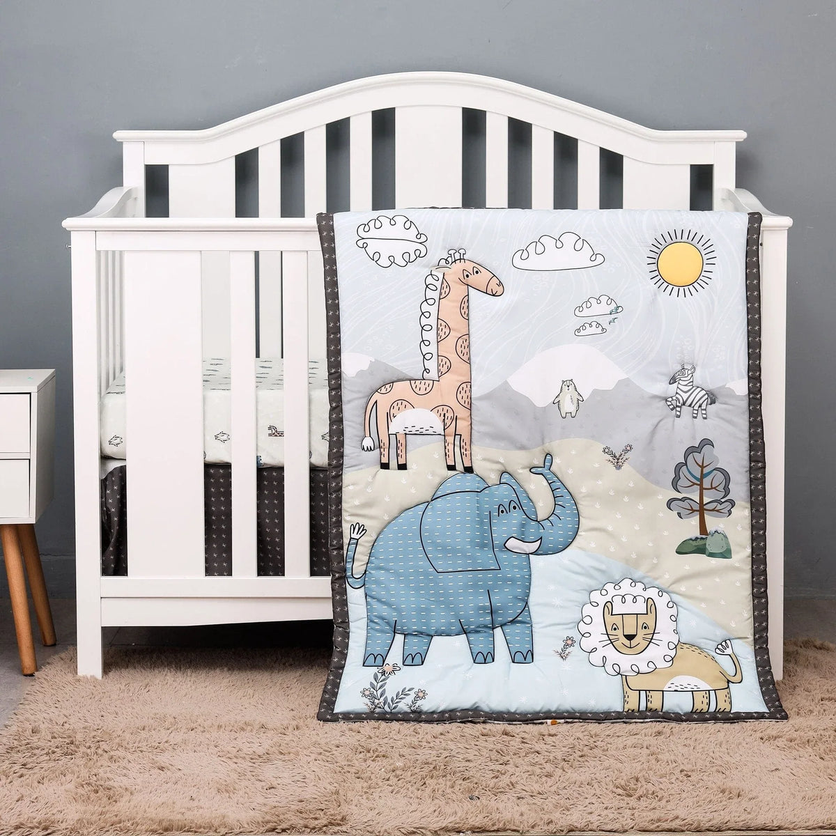 Blue and beige baby comfort set with animal designs including elephant, giraffe, and lion for infants