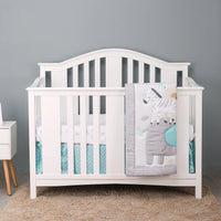 white baby crib with gray and blue zebra comfort set blanket draped over side for infants
