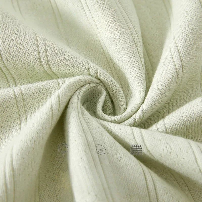 cream cotton baby romper long sleeve fabric close-up with ribbed texture for newborns
