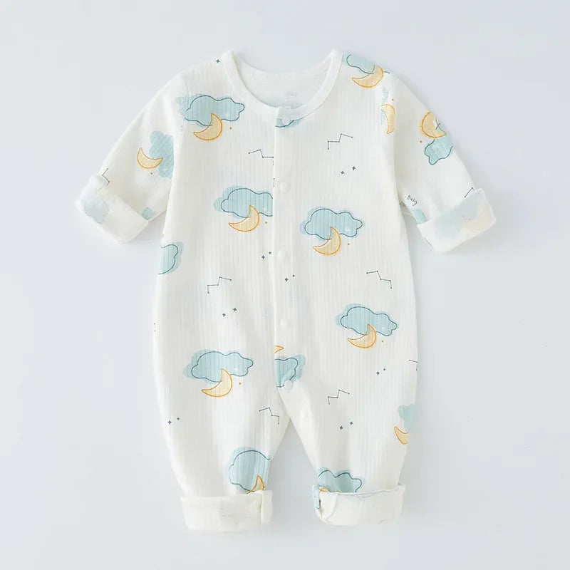 White cotton baby romper with snaps featuring blue clouds and yellow moons pattern