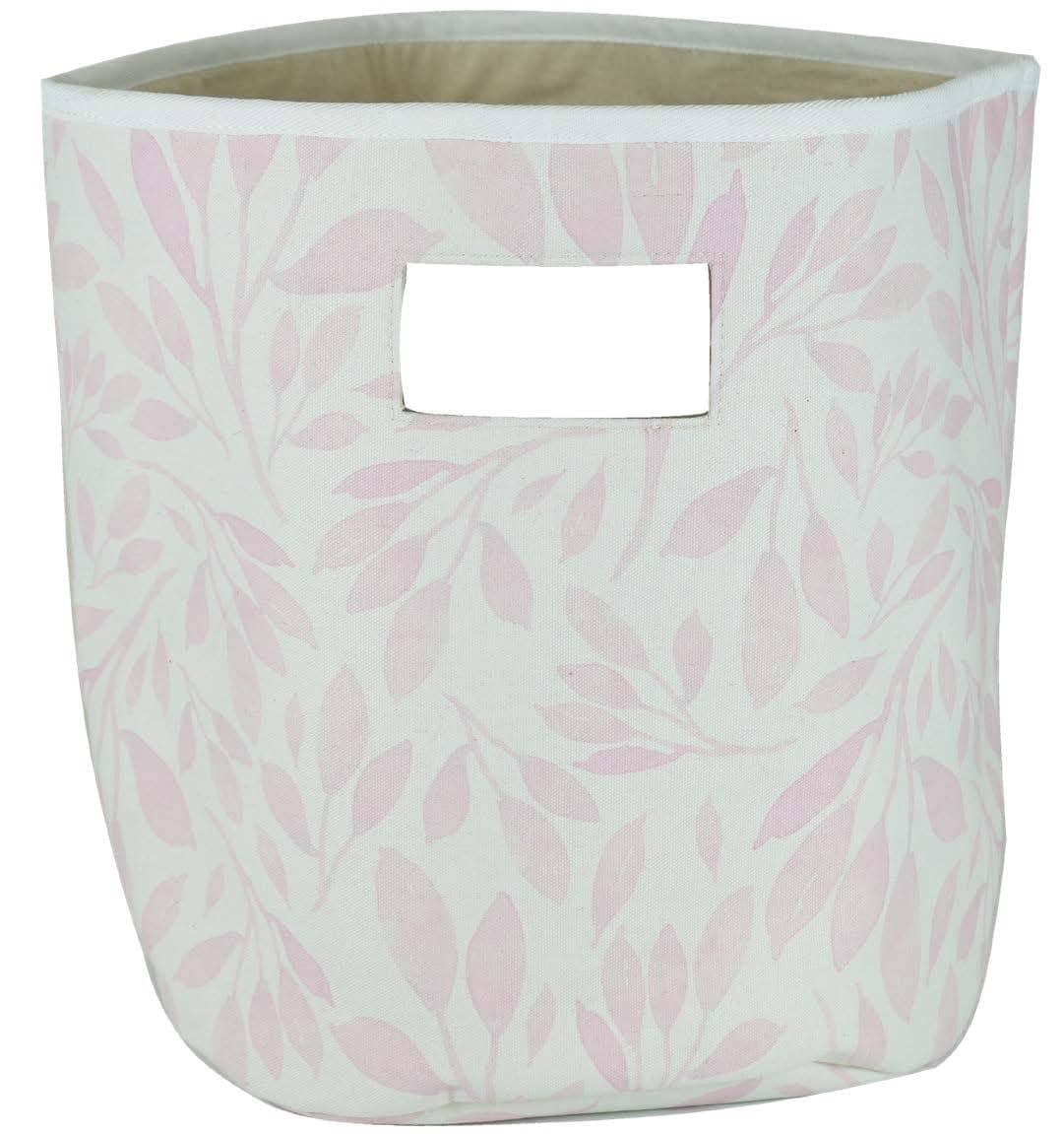 Pink and white fabric baby storage bins with leaf pattern and handle cutout for nursery organization