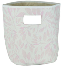 Pink and white fabric baby storage bins with leaf pattern and handle cutout for nursery organization