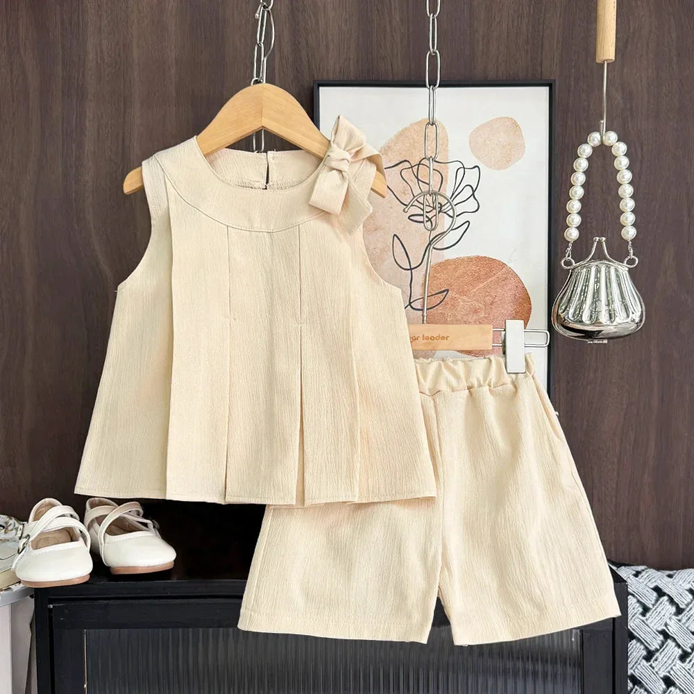 beige girls sleeveless top with bow and matching shorts set for toddlers