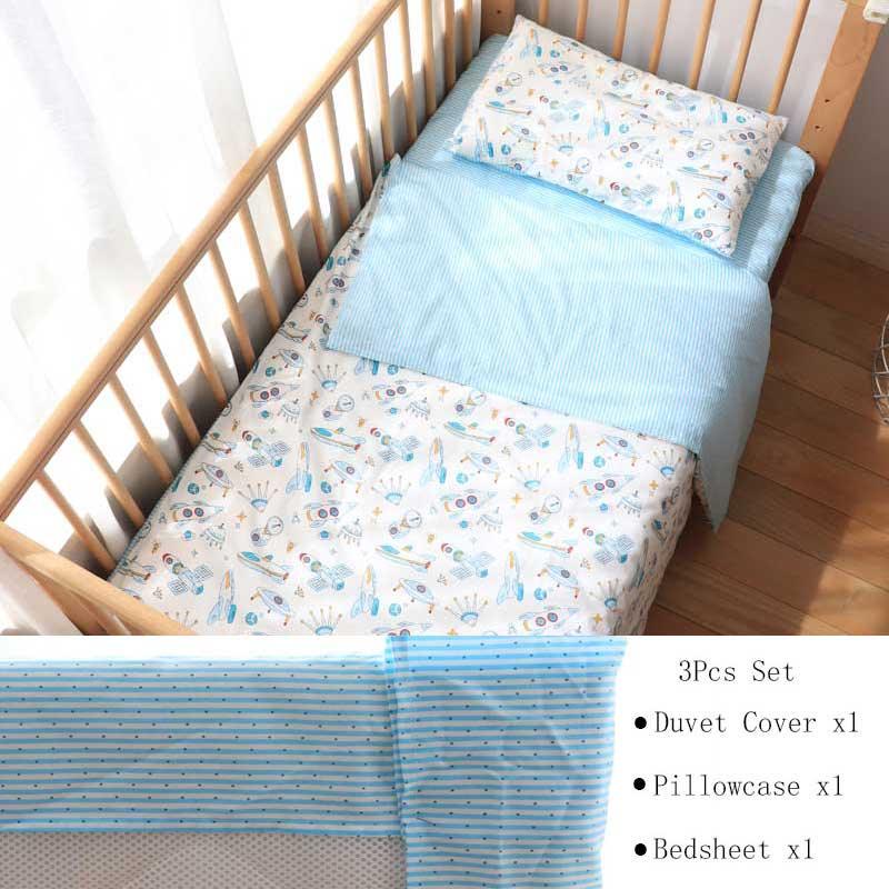 Blue and white nursery crib bedding set with space-themed pattern including duvet cover pillowcase and bedsheet for infants