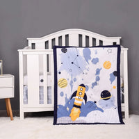 Toddler space-themed crib bedding set with rocket and planets in navy and yellow colors