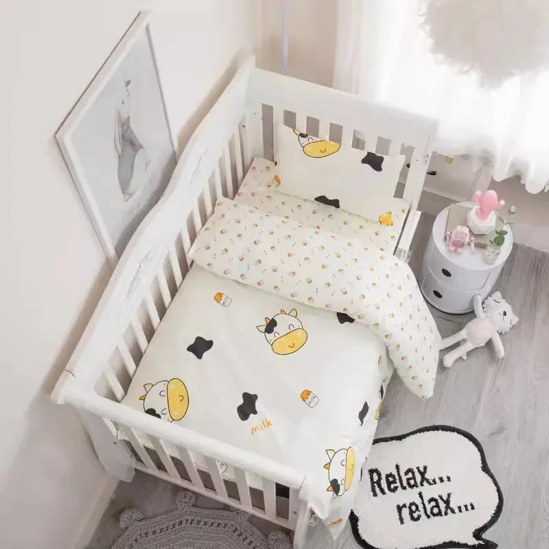 White baby crib with cow print crib bedding set including blanket and pillow for infant nursery