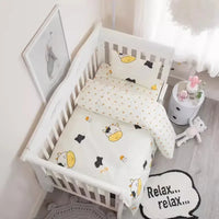 White baby crib with cow print crib bedding set including blanket and pillow for infant nursery