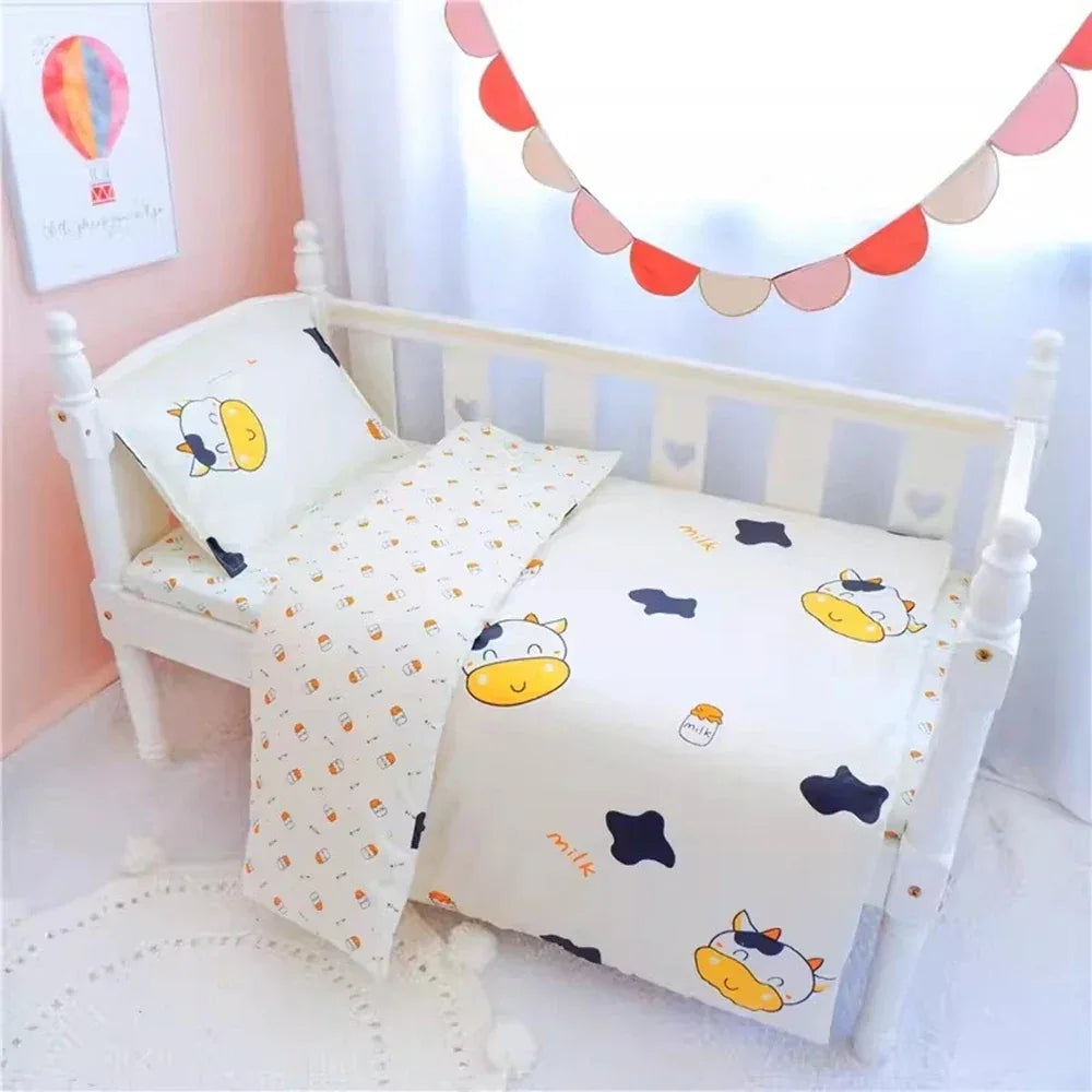 White crib bedding set for baby with cute cow and milk bottle prints in nursery