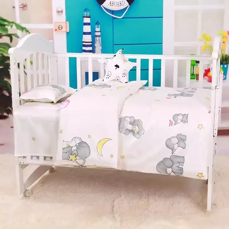 White baby crib with gray elephant print crib bedding set in a nursery with blue and white decor