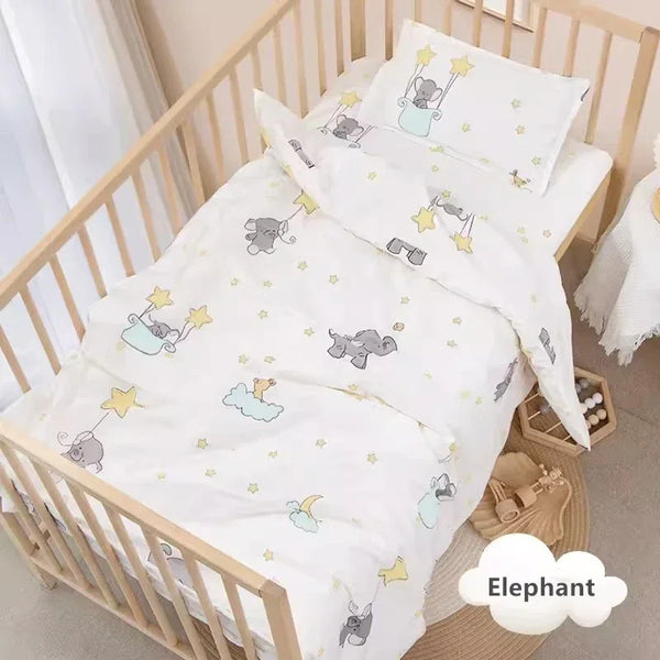 White crib bedding set with playful elephant and star print for baby nursery