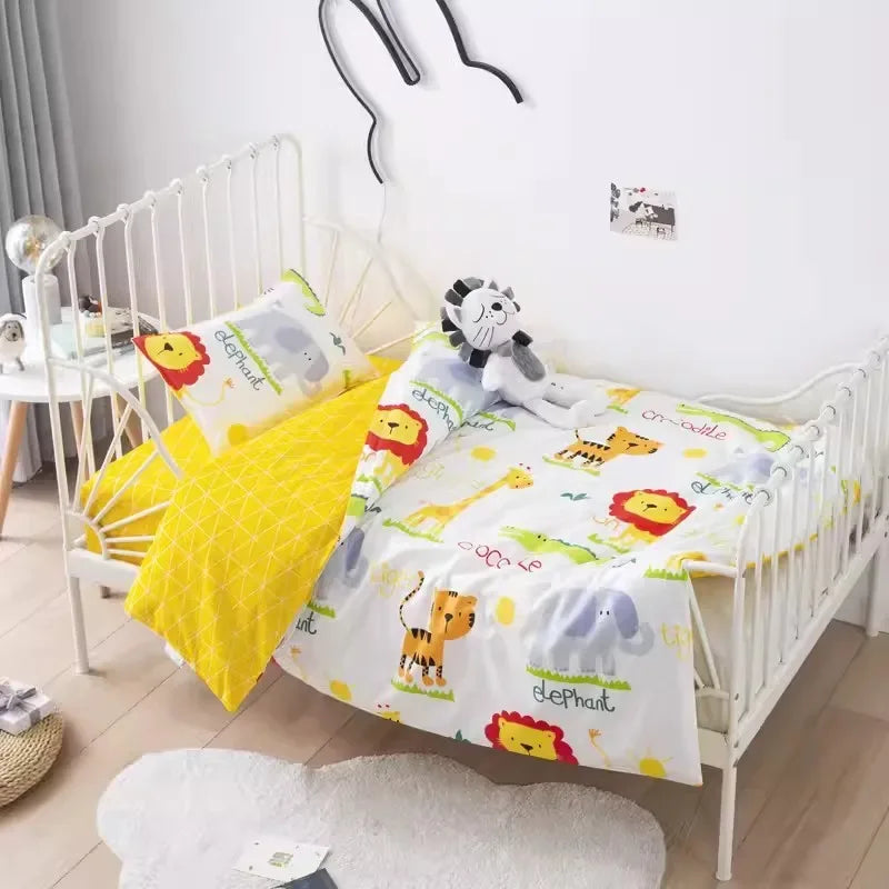 Colorful crib bedding set with jungle animals and yellow patterned blanket for baby nursery