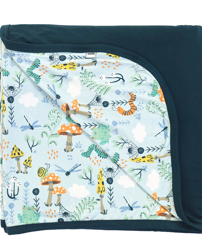 Children's blanket with nature-themed design on a white background