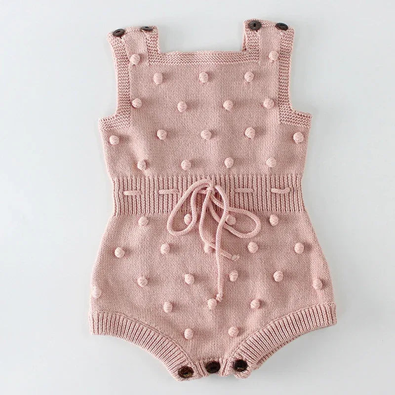 pink cute knit baby romper for infants with textured bobble details and button straps