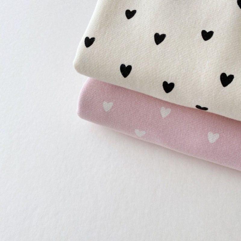 babies warm up set with black heart print on cream fabric and white heart print on pink fabric