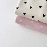 babies warm up set with black heart print on cream fabric and white heart print on pink fabric