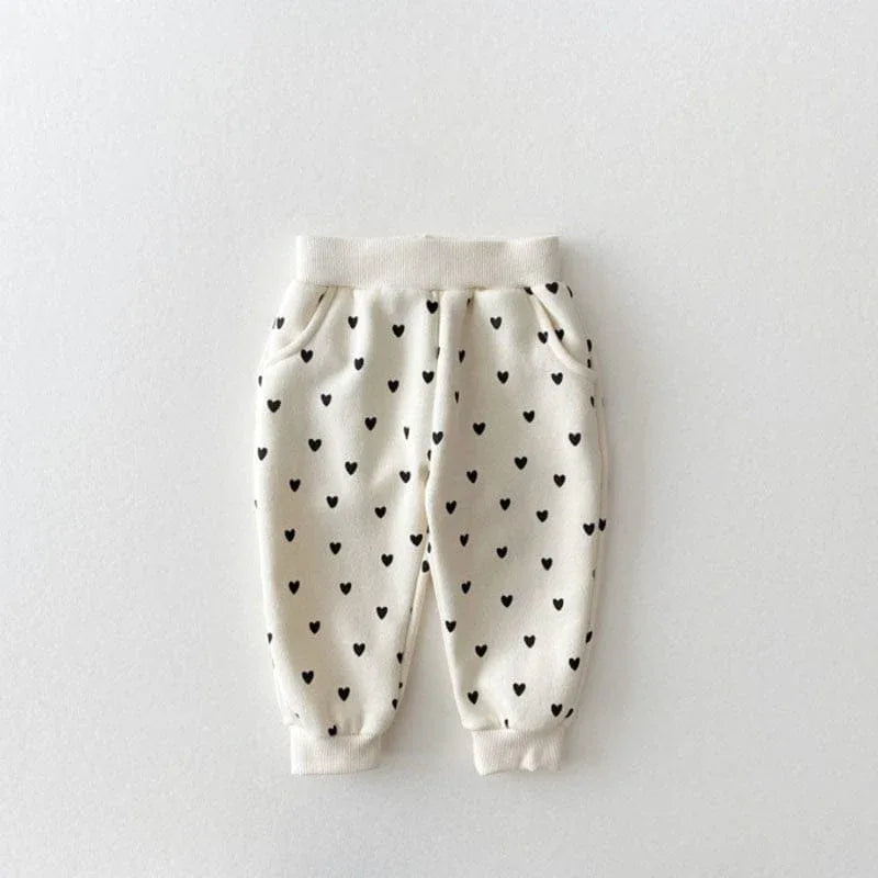 baby cream warm up set pants with black heart pattern and elastic waistband
