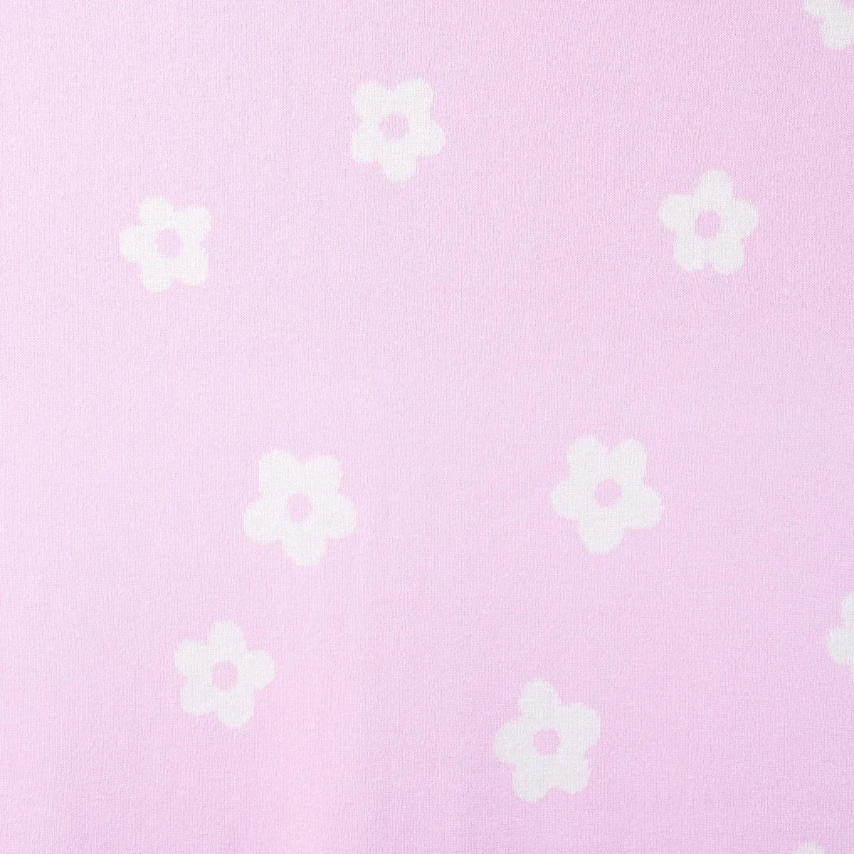 Macro view of repeating white five-petal daisies with pink centers evenly spaced across light pink 100% cotton jacquard
