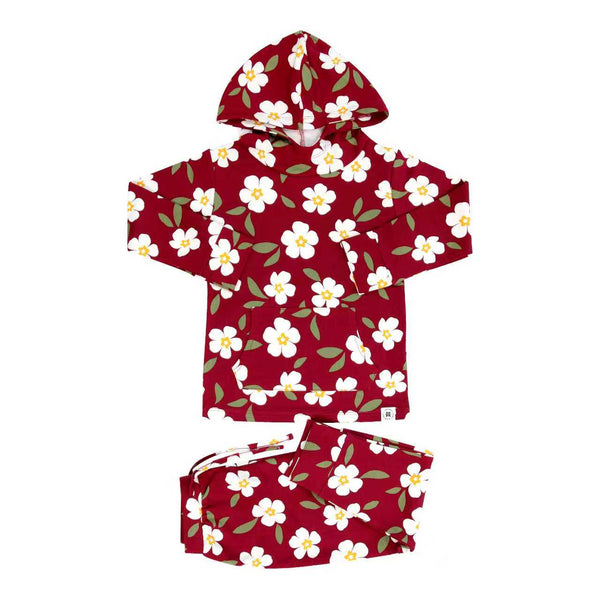 Red floral children's hooded jogger set with front pocket, featuring white flowers and green leaves on maroon fabric.