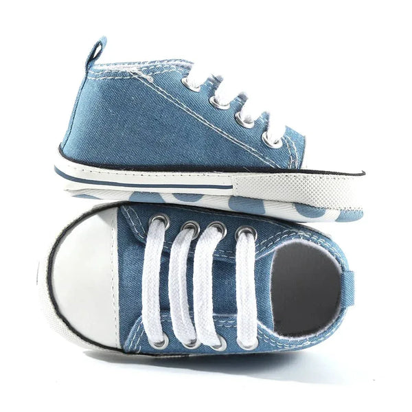 Denim baby first walkers in blue with white laces and rubber sole for infants learning to walk