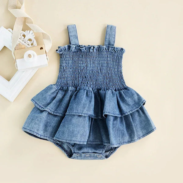 Denim blue baby romper for infants with smocked bodice and layered ruffle skirt