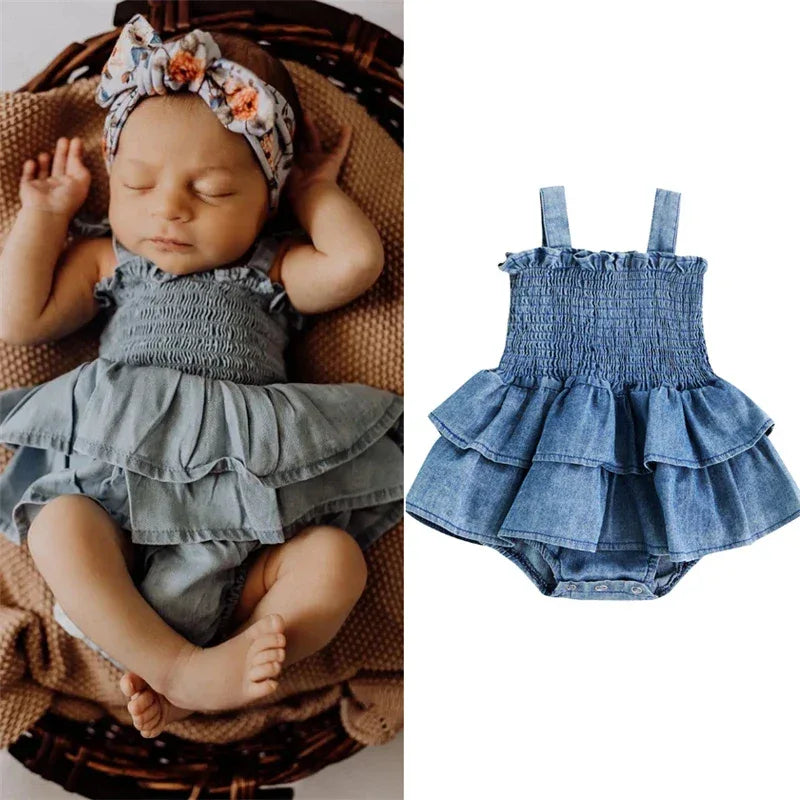 Denim blue baby romper for infants with ruffled skirt and smocked bodice