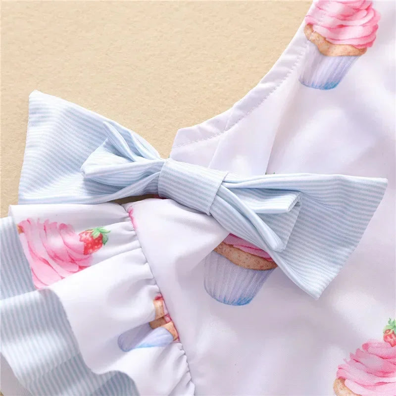 baby dessert themed baby swimsuit with pink cupcake prints and blue striped bow detail