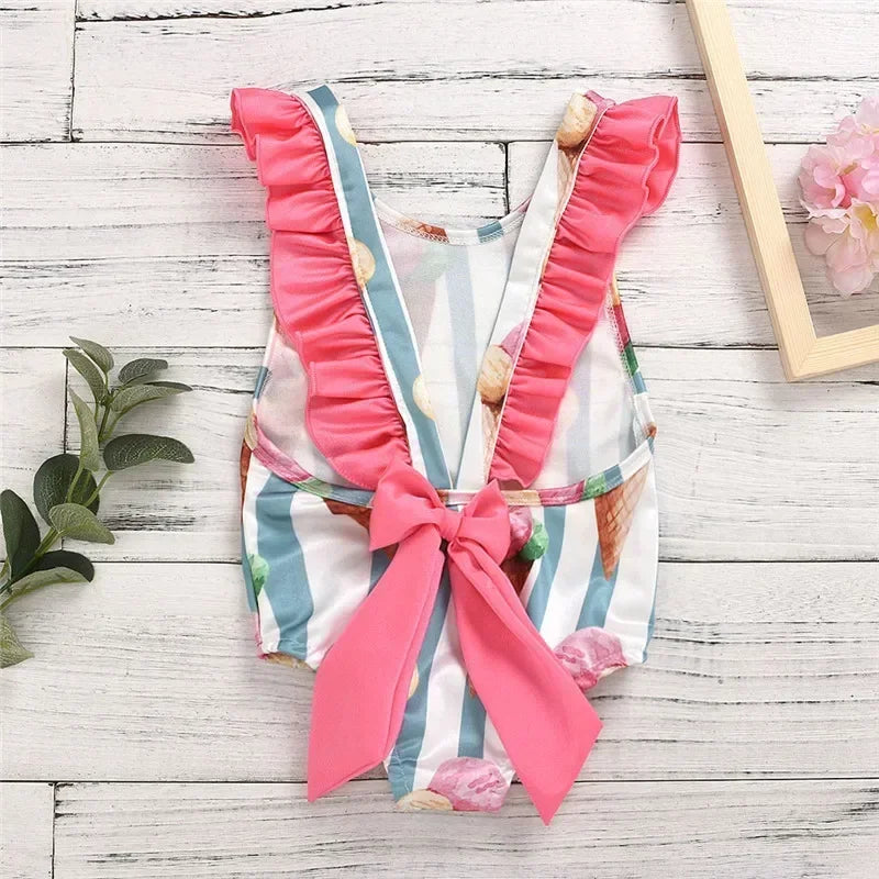 Dessert themed baby swimsuit with pink ruffle straps and bow for infants 18 to 21 months