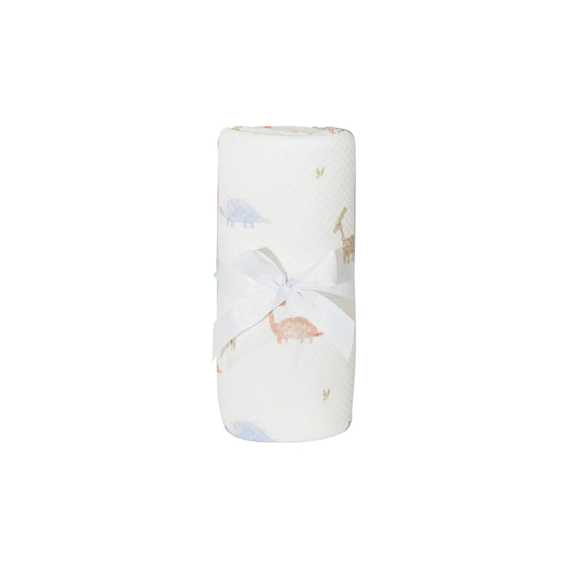 white dinosaur knit baby blanket with pastel dinosaur prints tied with white ribbon newborn size
