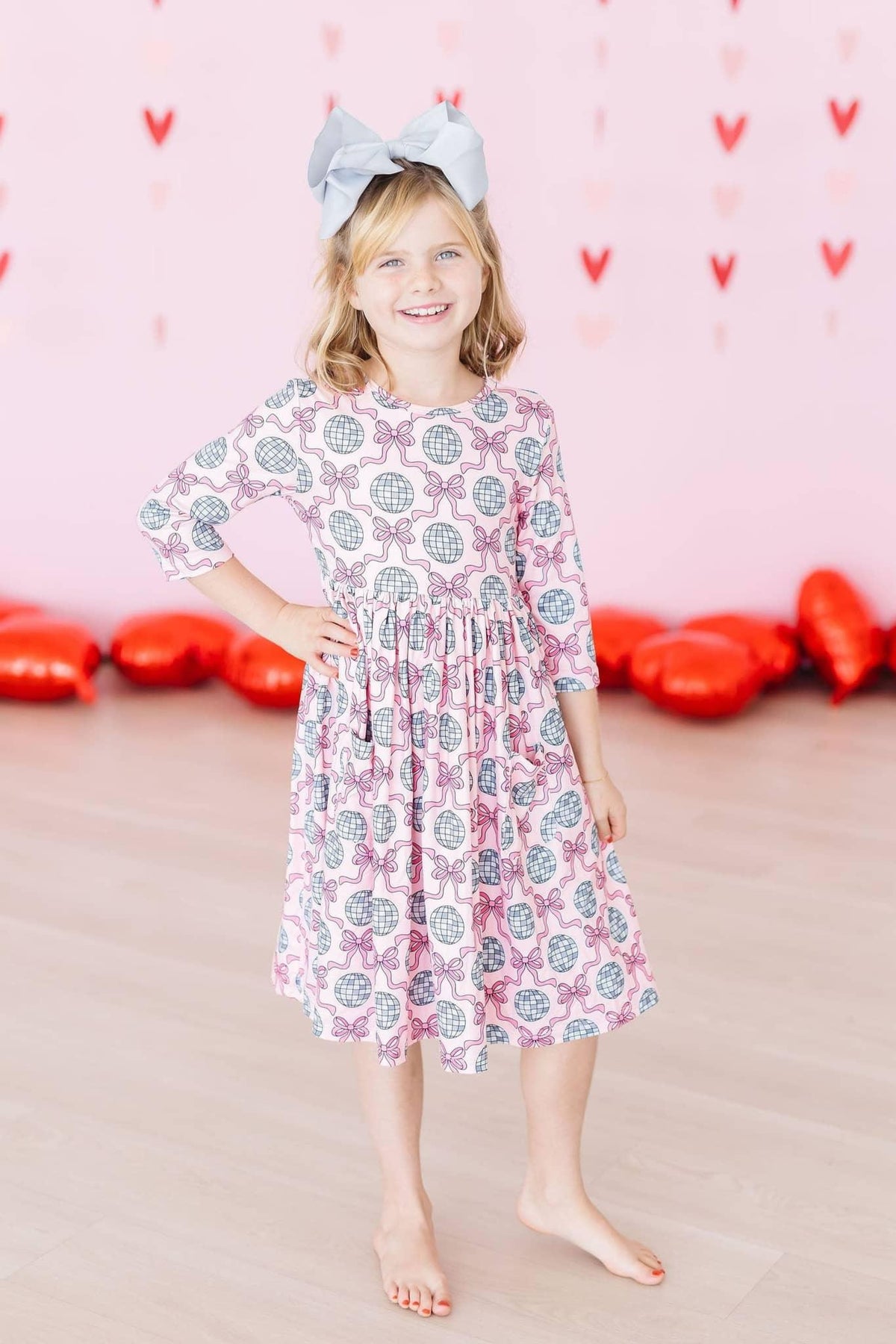 Girls pink and gray disco bow twirl dress for girls with 3/4 sleeves and pocket detail