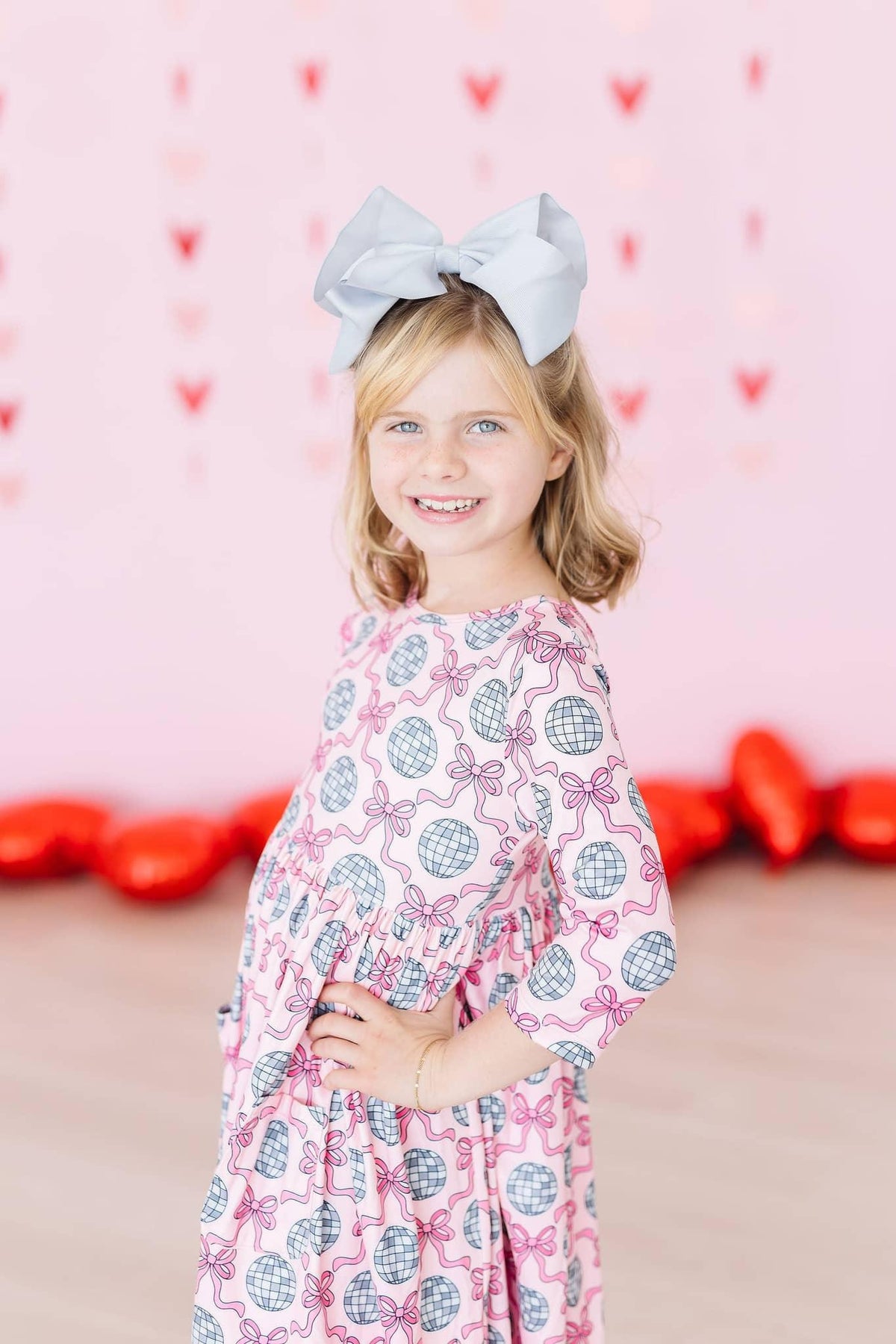 Girls pink disco bow twirl dress for girls with 3/4 sleeves and pocket by Mila & Rose