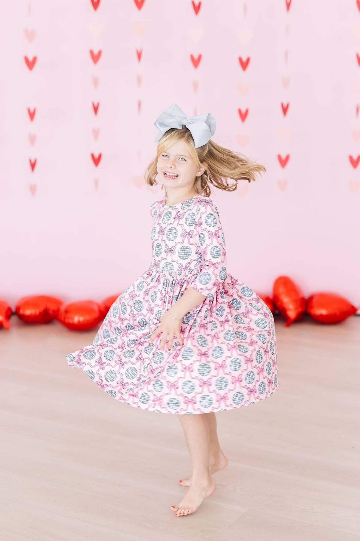 Girls pink and gray disco bow twirl dress for girls with 3/4 sleeves and floral pattern