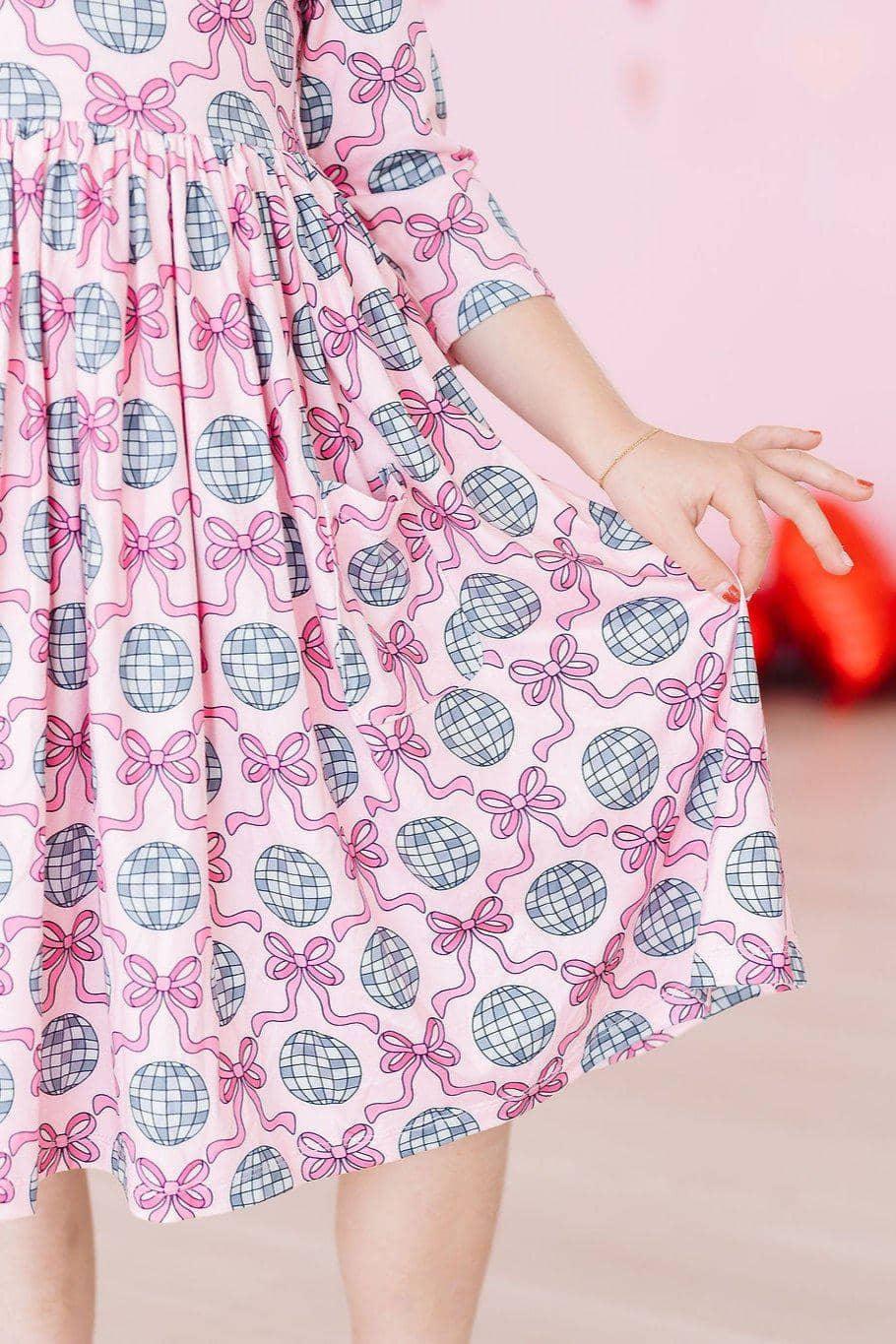 Girls pink disco bow twirl dress for girls with 3/4 sleeves and disco ball pattern