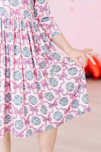 Girls pink disco bow twirl dress for girls with 3/4 sleeves and disco ball pattern