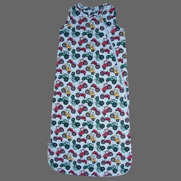 Baby romper with tractor pattern on a gray background