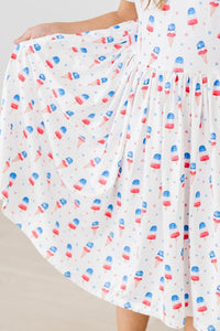 Girls white twirl dress for the summer with red blue popsicle print and flutter sleeves