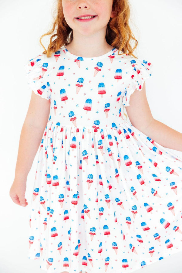 Girls white twirl dress for the summer with red blue popsicle print and flutter sleeves