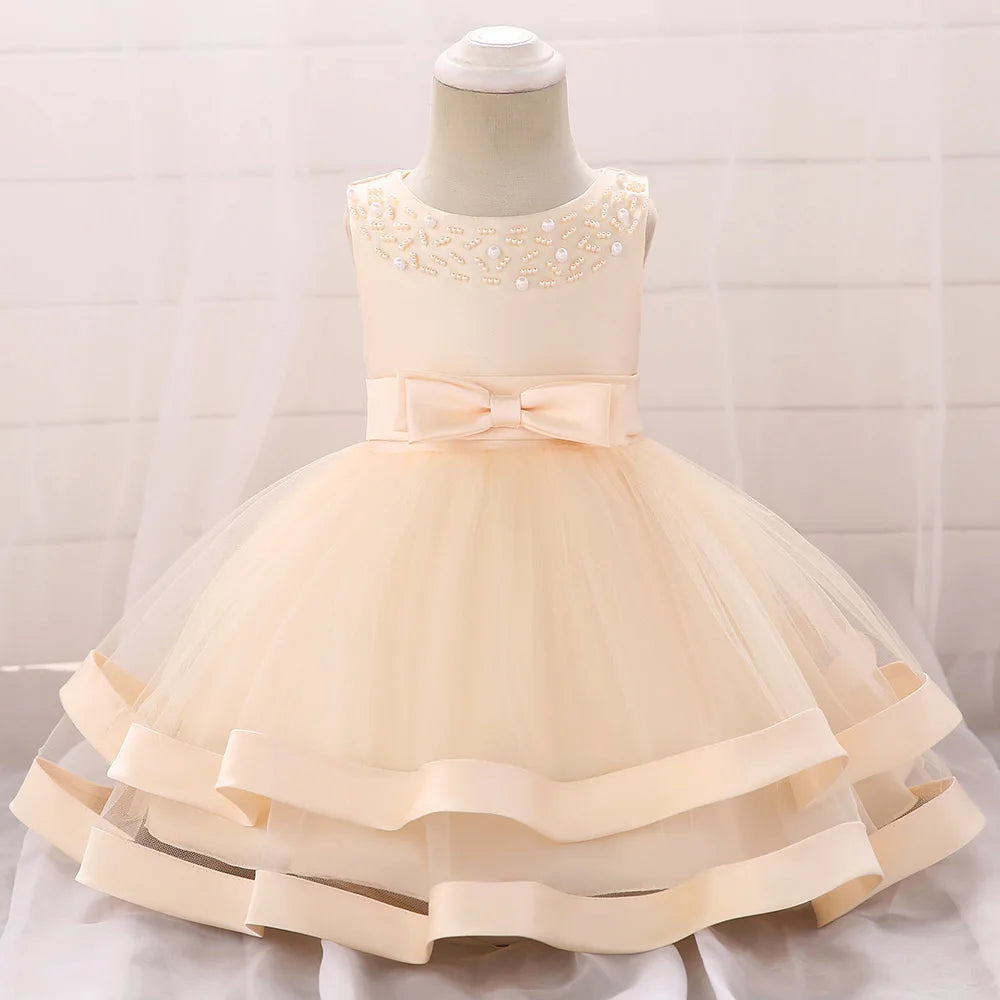 baby and toddler cream special occasion dress with bow and beaded neckline dress for wedding party guest