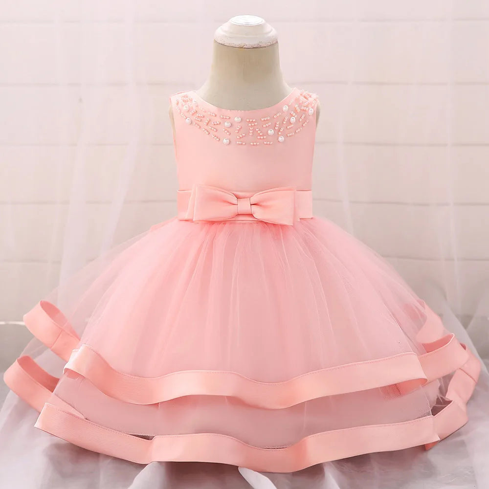 Pink babies dress for wedding party guest with bow and pearl bead detailing, special occasion tulle skirt