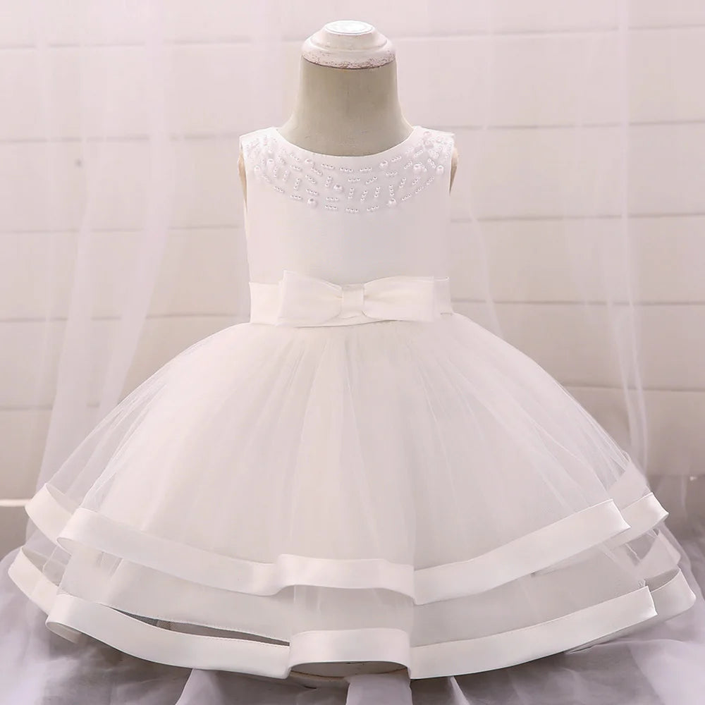 White babies special occasion dress for wedding party guest with beaded neckline and bow detail