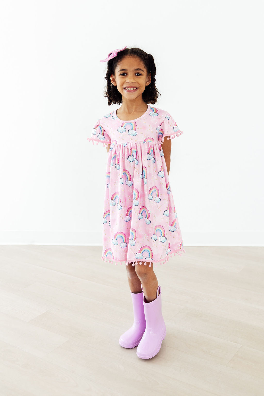 Girls pink pom pom dress with rainbow print dress with rainbow, short sleeves and scalloped hem