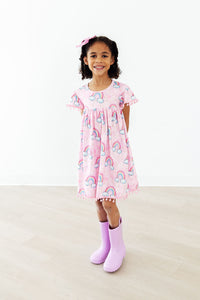 Girls pink pom pom dress with rainbow print dress with rainbow, short sleeves and scalloped hem