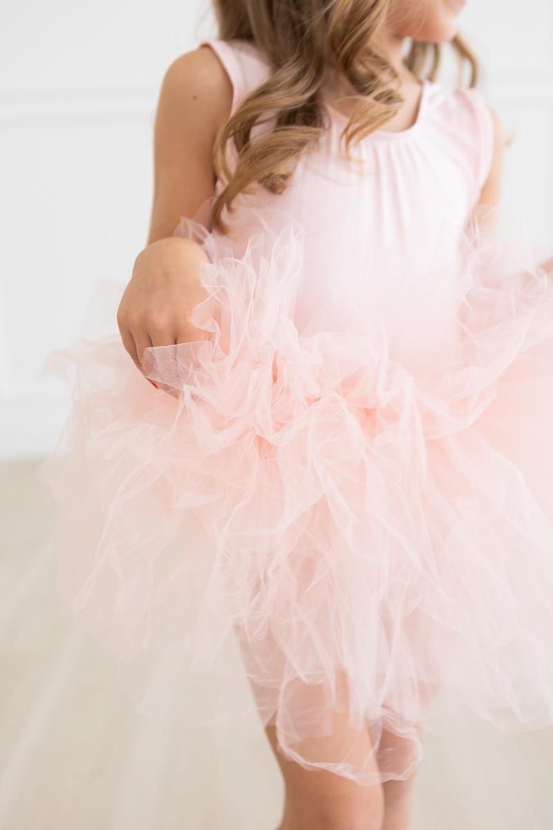 Side view of a young dancer in the 'Elana' Ballet Pink Tank Tutu Leotard, emphasizing the layers of tulle for a full tutu.