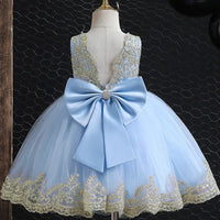elegant baby girl party dress in light blue with gold lace and large satin bow on mannequin